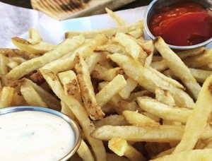 photo of french fries with ranch and ketchup dipping sauces