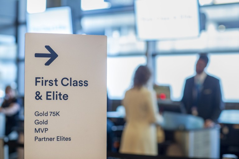 This is a photo of a First CLass boarding line at the Seattle Airport.