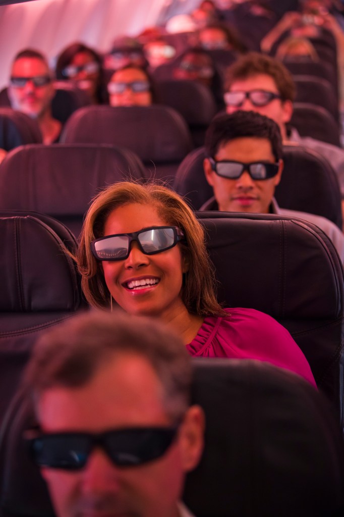 Danielle Nottingham, with CBS news out of Los Angeles, sports some eclipse viewing shades on Alaska Airlines Great American Eclipse Flight.