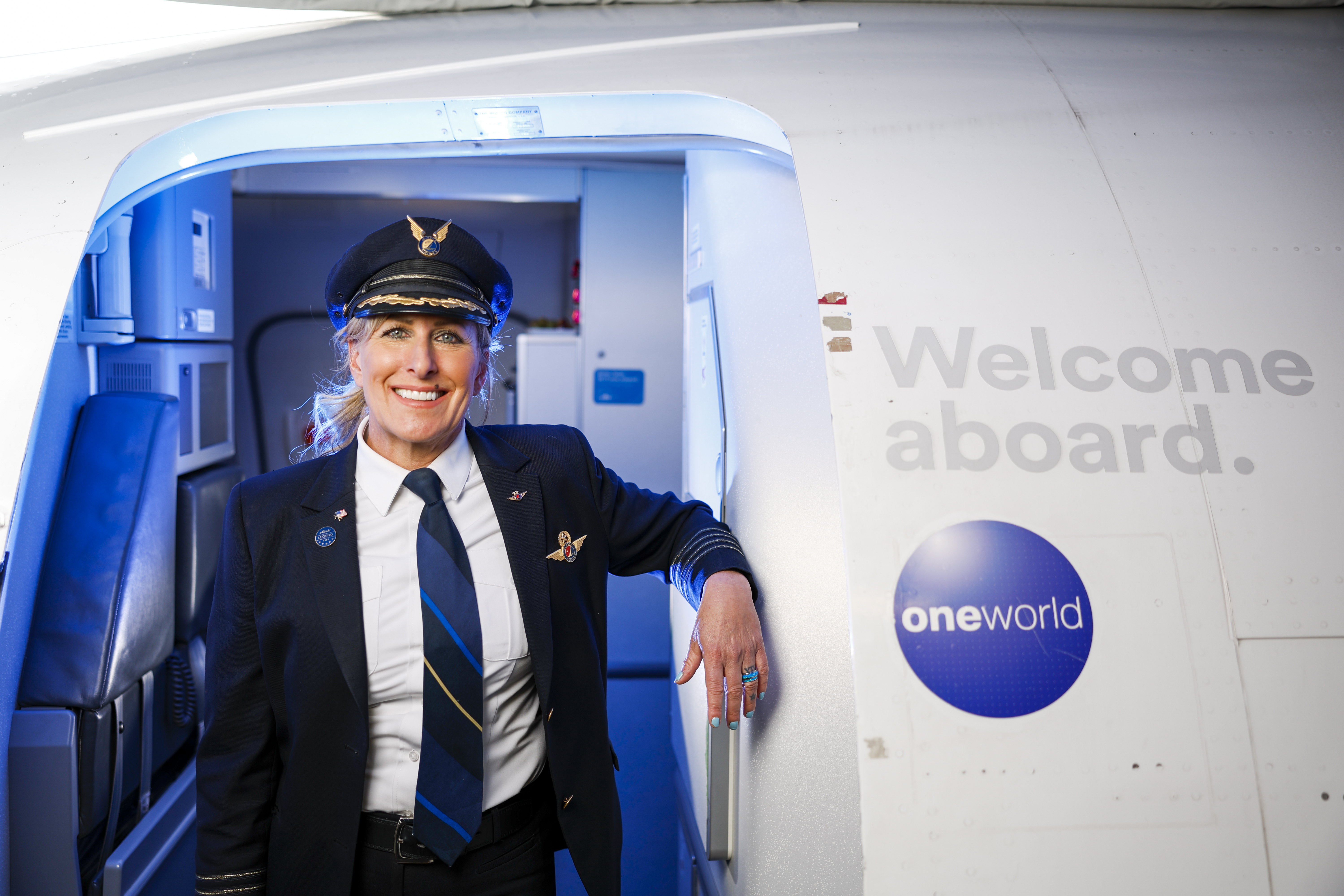 Alaska Airlines 2023 Legend Julie Thiele Guest with newspaper in Plumeria Lounge