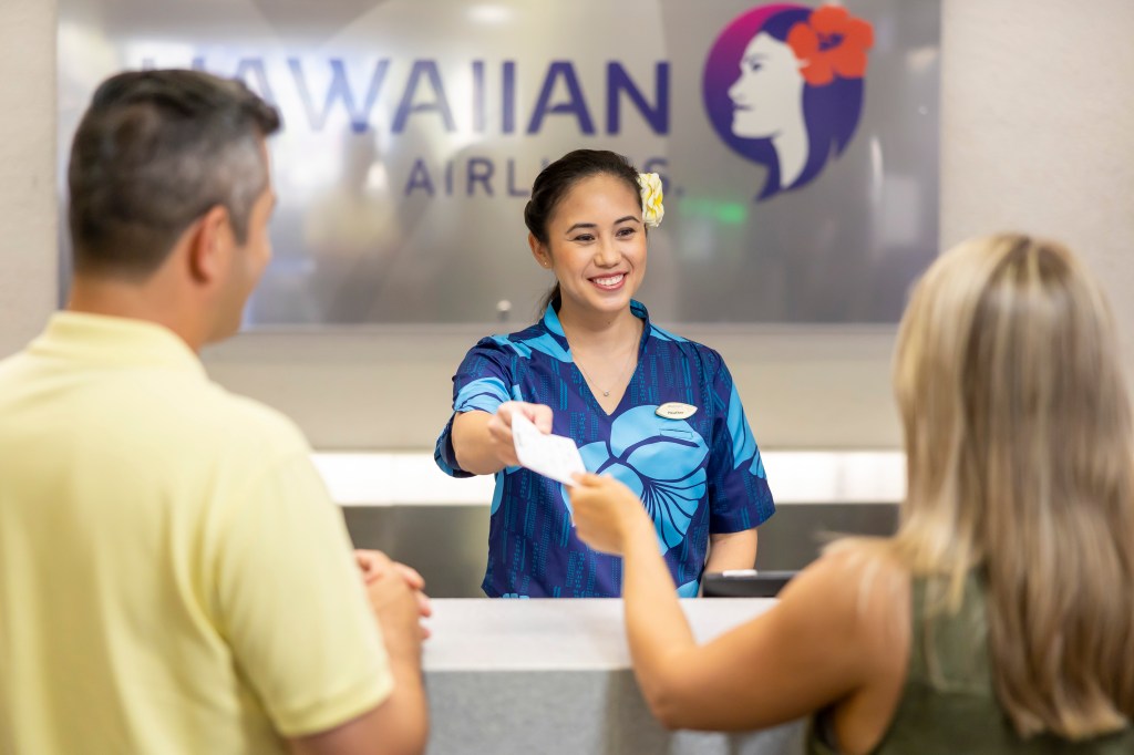 HAL Lobby, HNL, Guest Services HA Guest Service Agent assisting customers