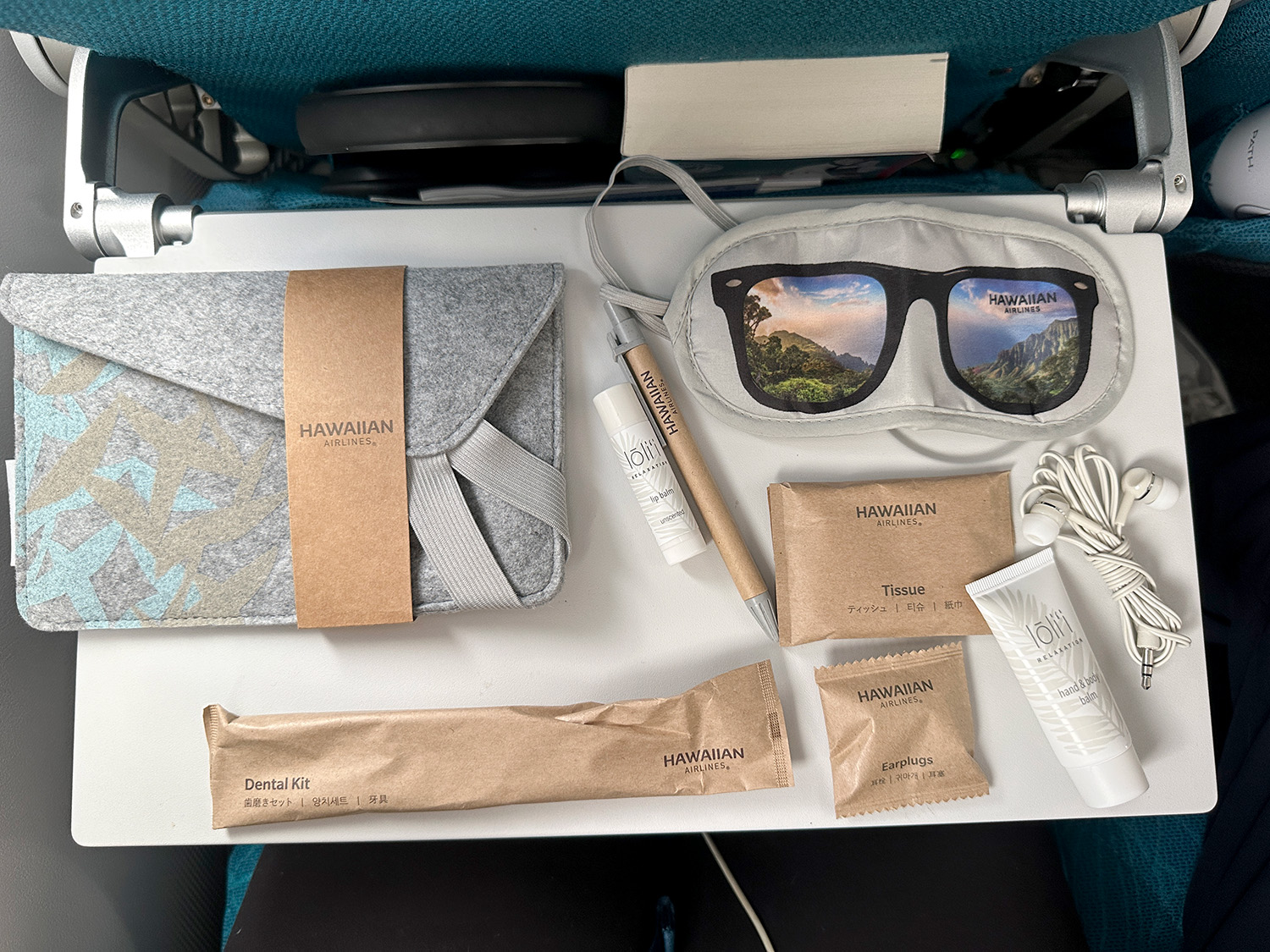 amenity Extra comfort amenity kit items, shown on the seat's tray table.