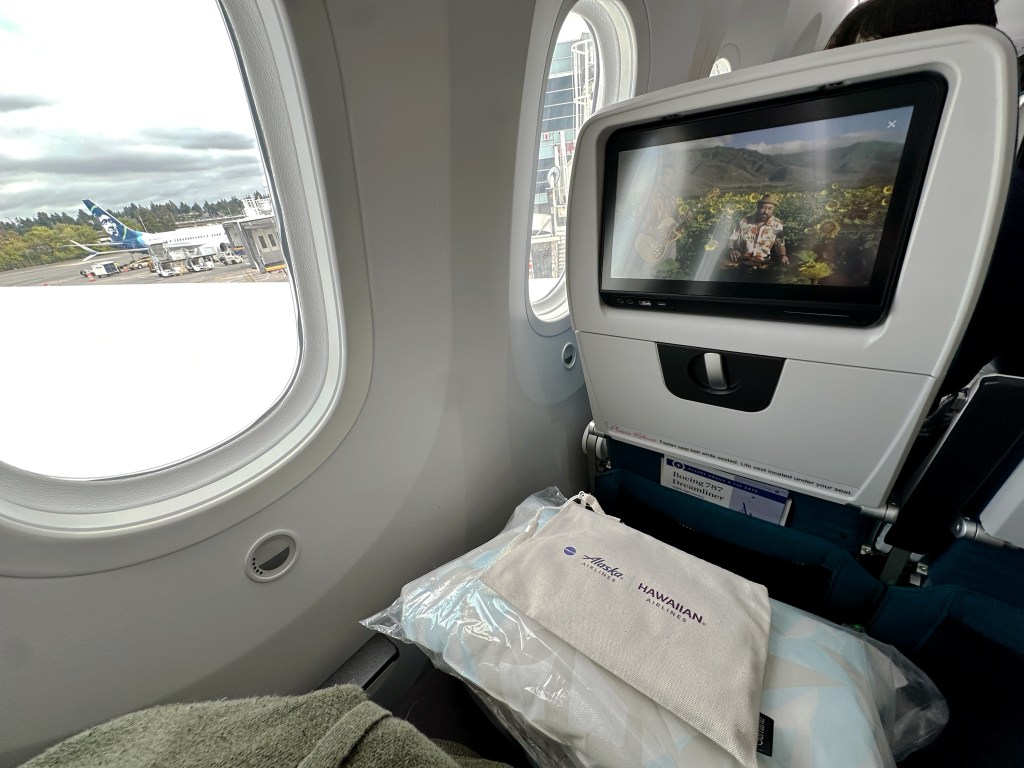 exco_45a8e4 The author's photo of her seat while in Extra Comfort, with an Alaska Airlines tail window shot.