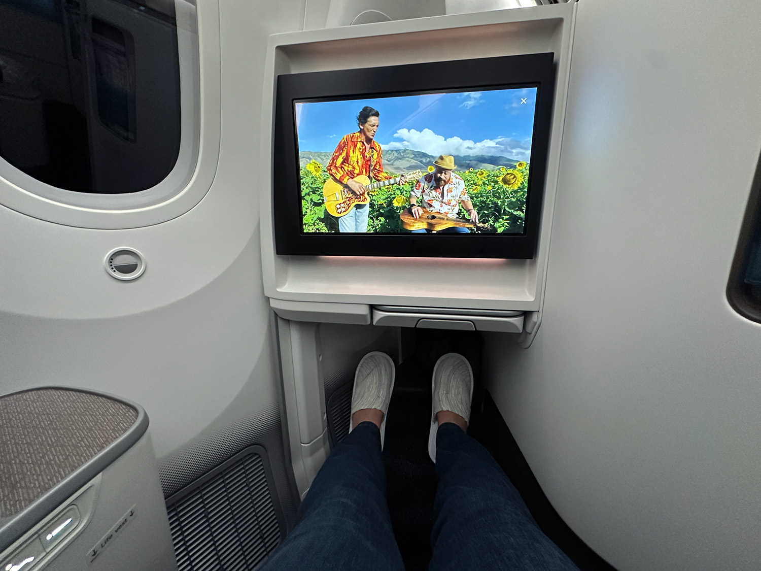 slippers The author pictured wearing her slippers with her feat outstretched in the lie-flat seat.