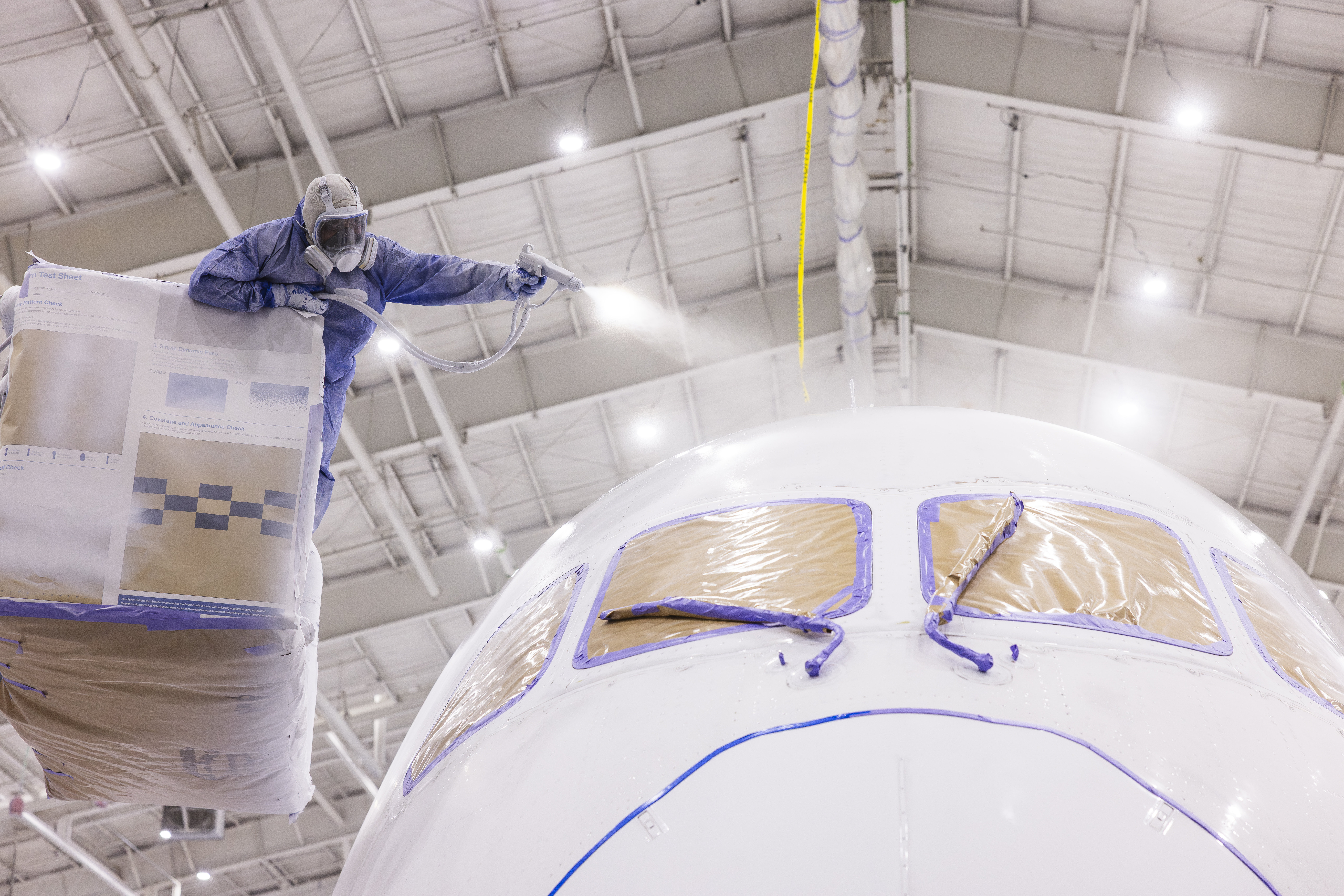 Painter spraying the aircraft with paint