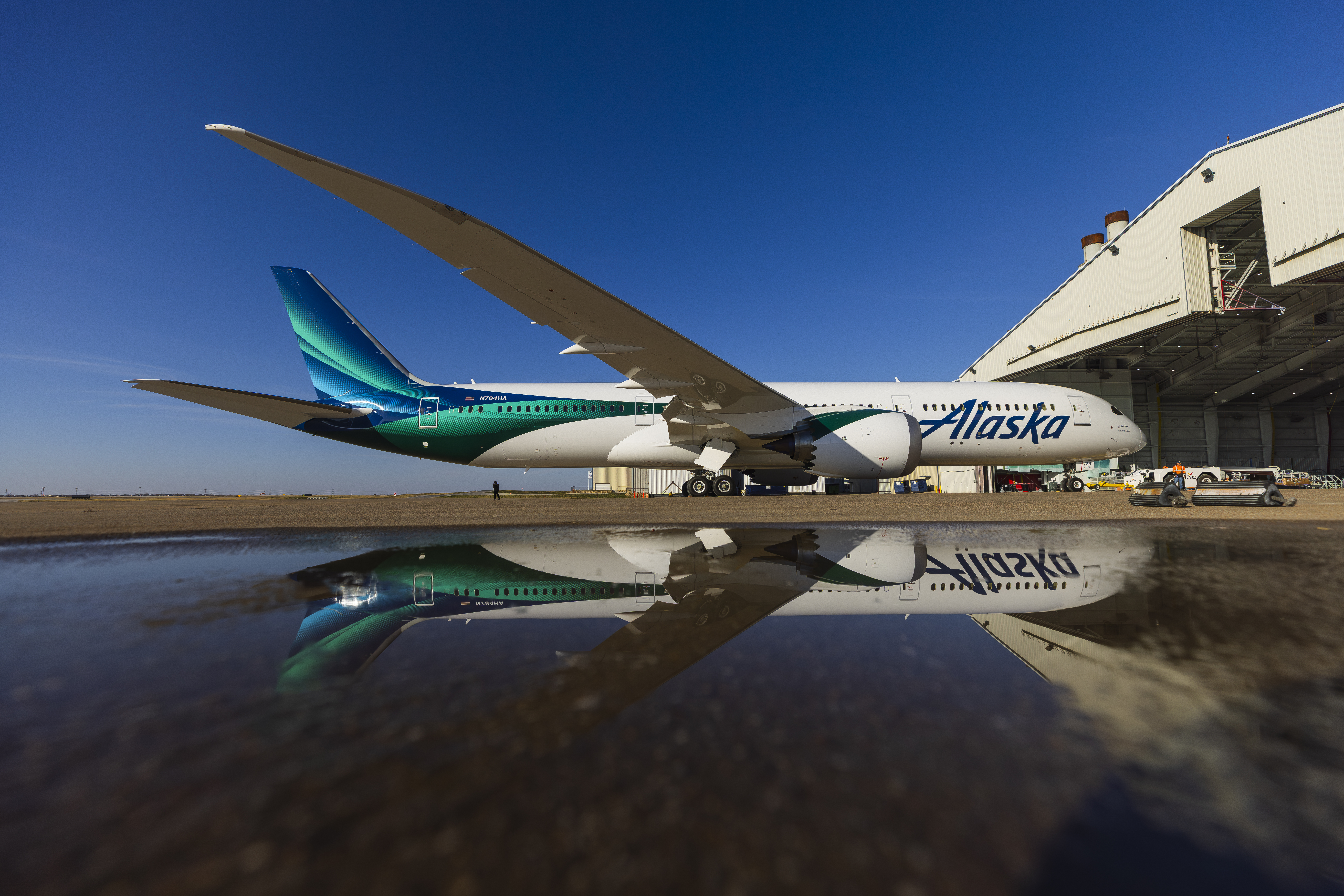Alaska Airlines global livery in front hangar