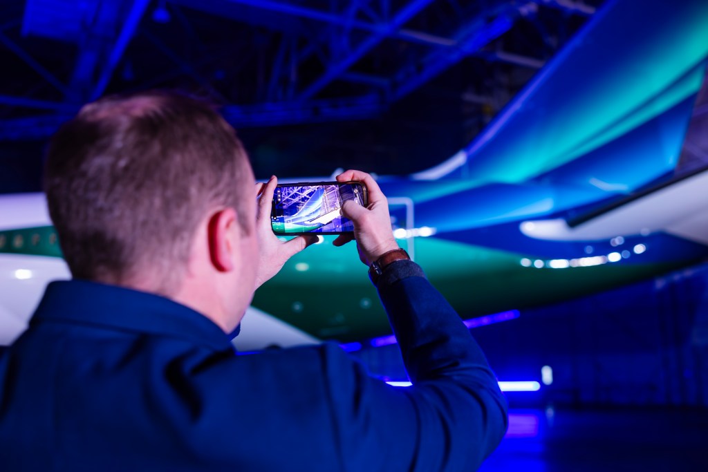 Employee photographing the Boeing 787