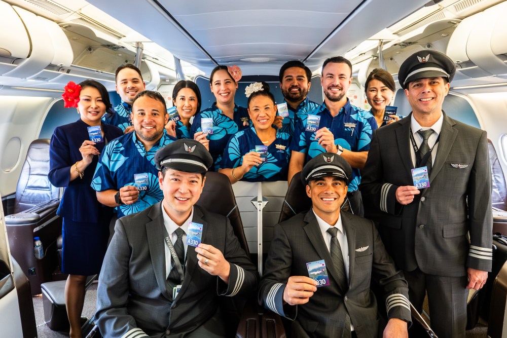 HA crew holding up the Hawaiian language trading card