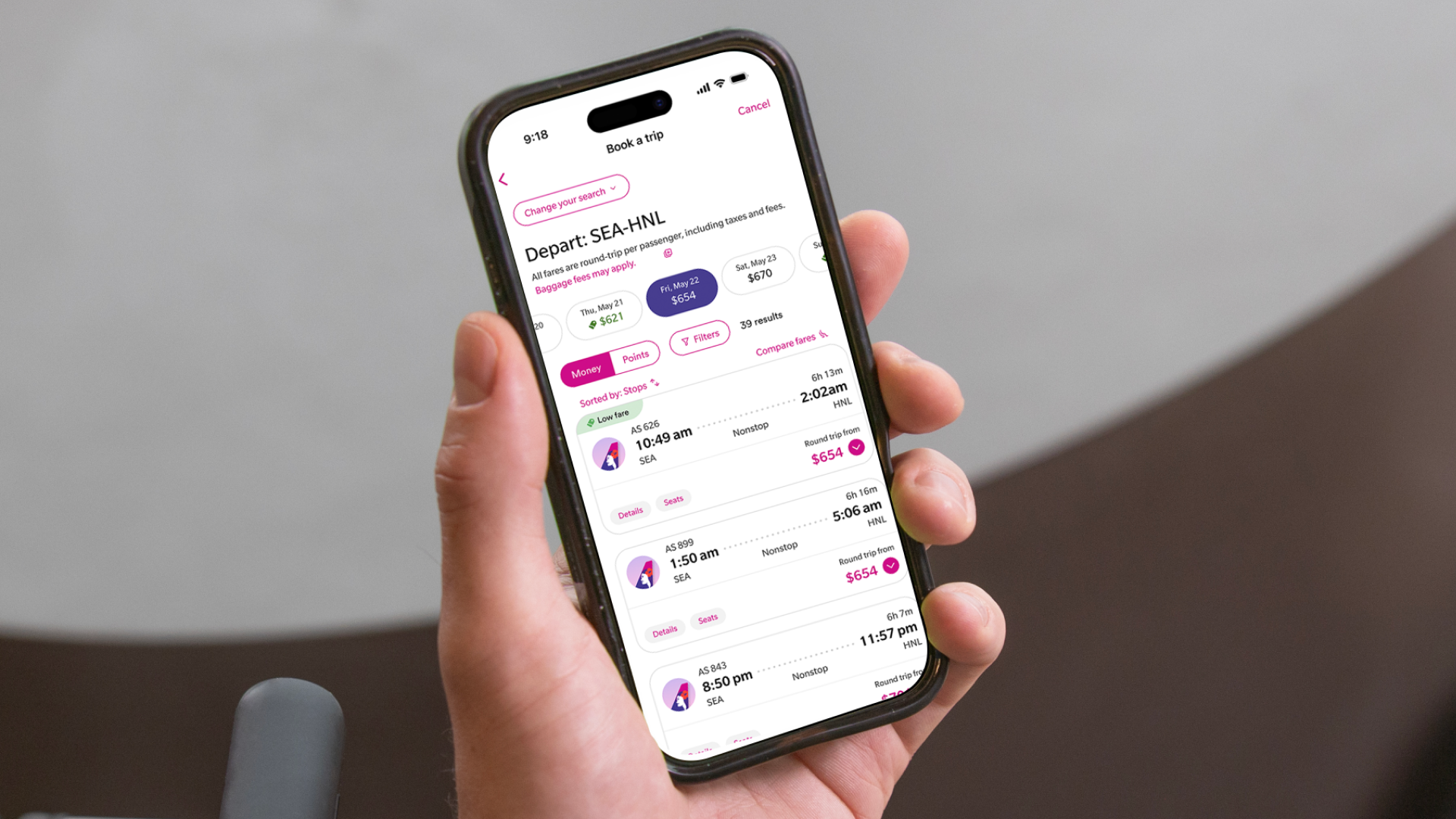 Alaska Hawaiian app user holding phone