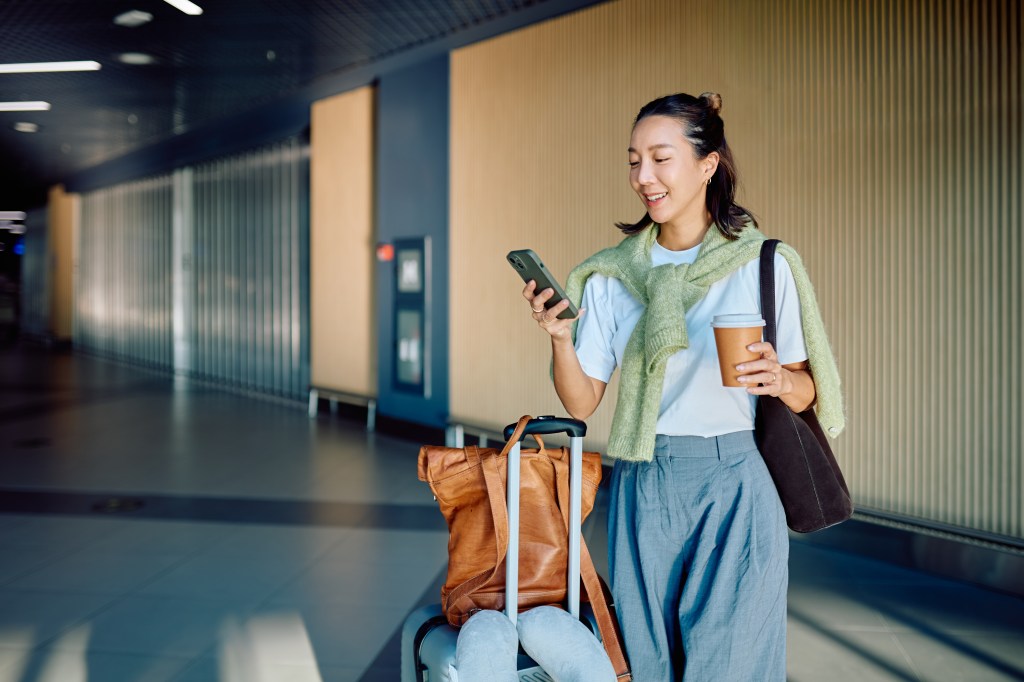 Woman on phone while walking through airport