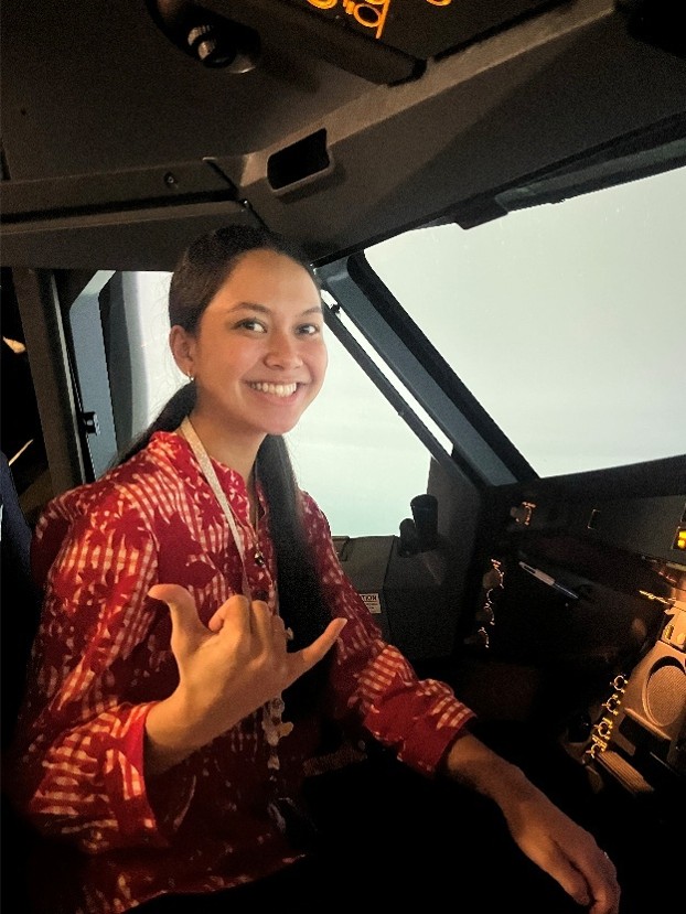 Image of intern sitting in a flight simulator