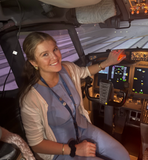 Image of intern sitting in a flight simulator