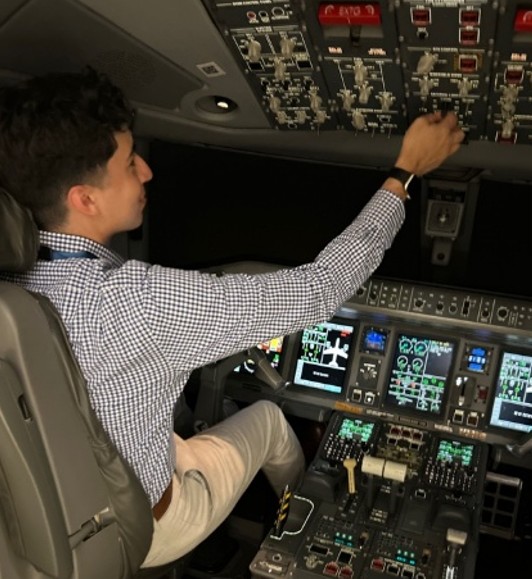 Image of intern flying a flight simulator