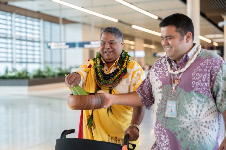 Hawaiian Airlines lounge blessing. Kahu with ti leaf at HNL