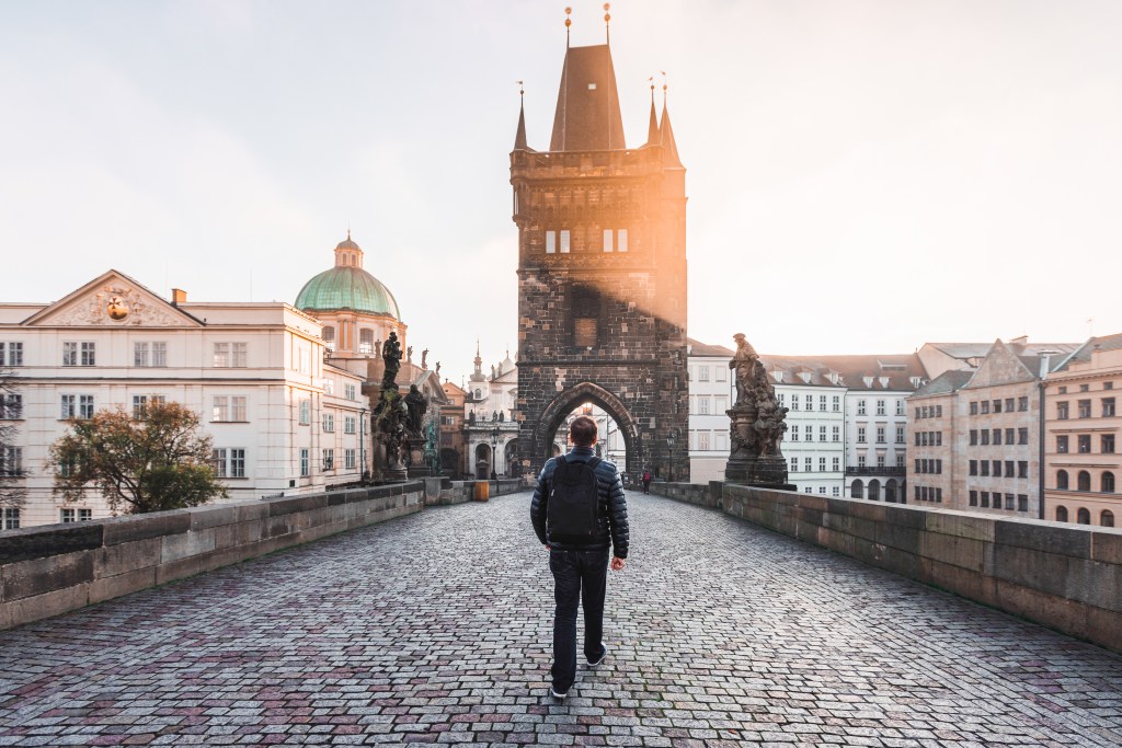 Rear view of a man walking on the Charles Bridge in Prague, Czech Republic