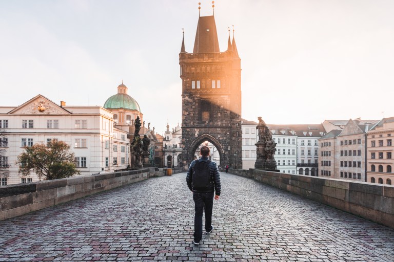 Rear view of a man walking on the Charles Bridge in Prague, Czech Republic